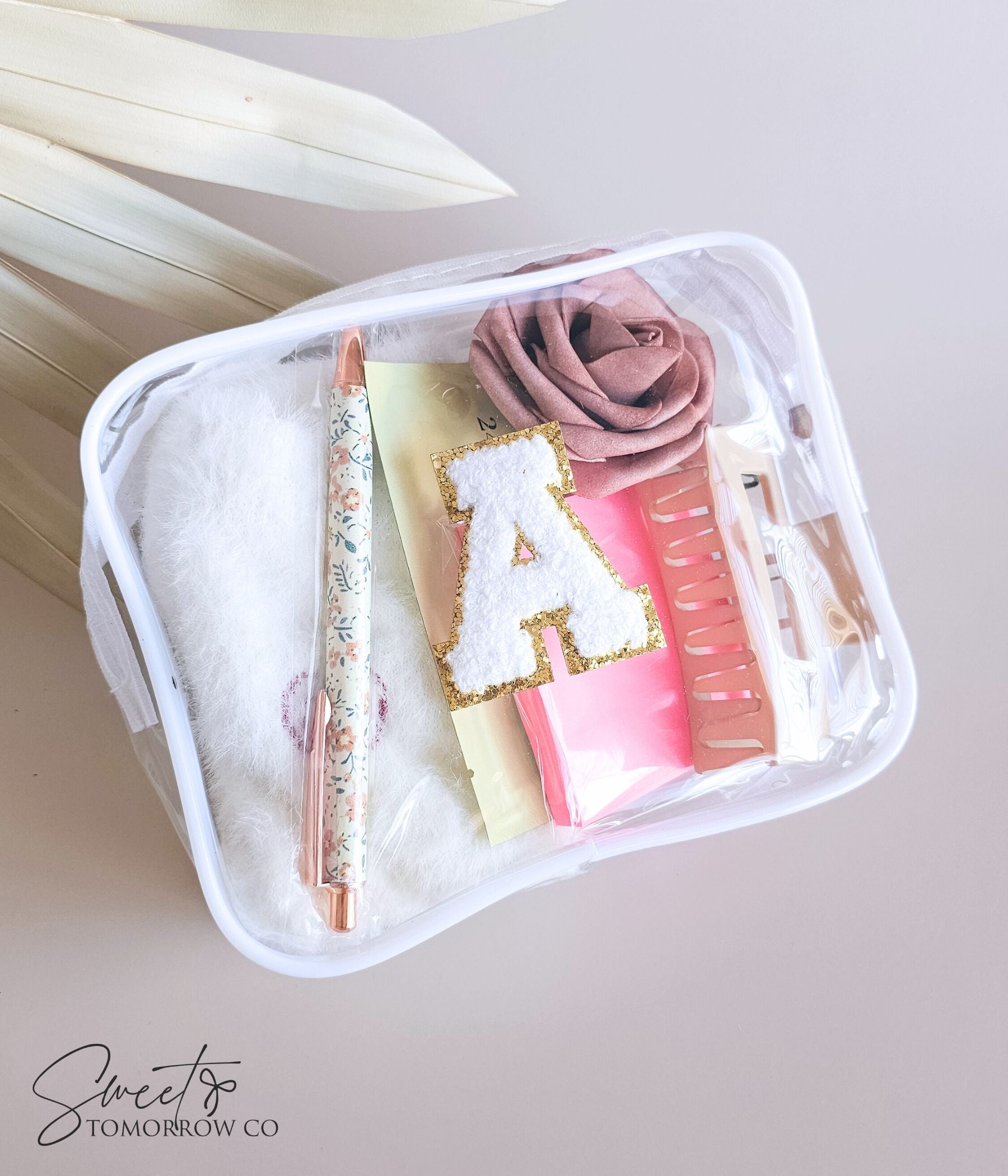 Teacher survival kit gift pouch with fuzzy socks, sticky notes, and blush rose accent