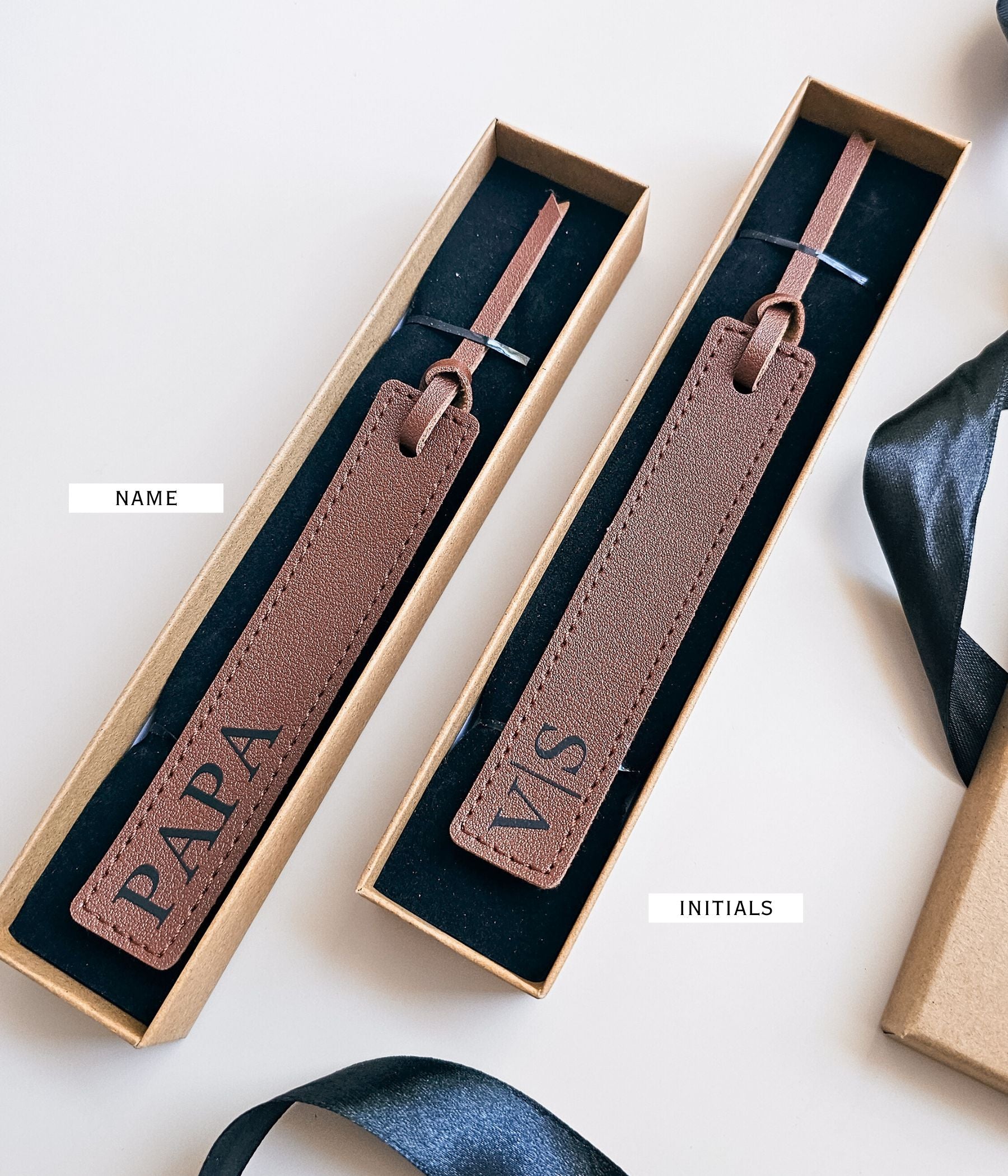 One-sided custom faux leather bookmark packaged in a kraft gift box with ribbon