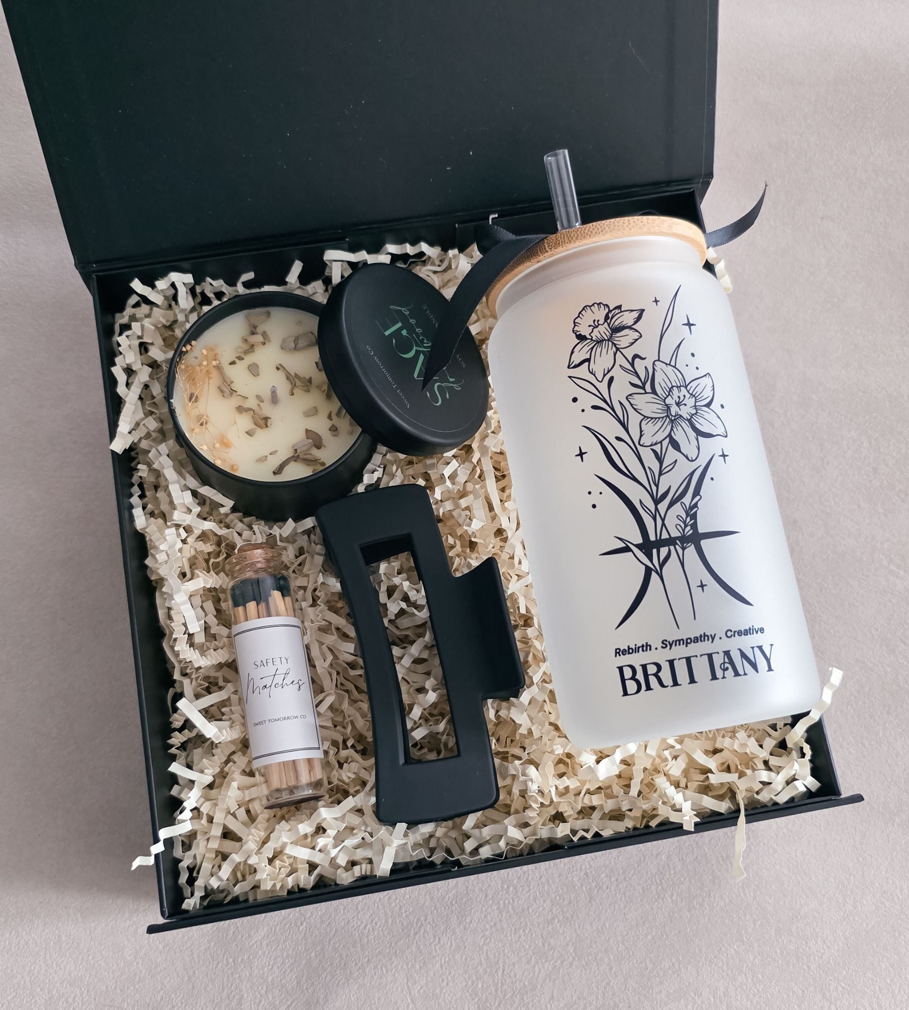 Deluxe zodiac gift box with tumbler, soy candle, hair clip, and safety matches inside a black magnetic box