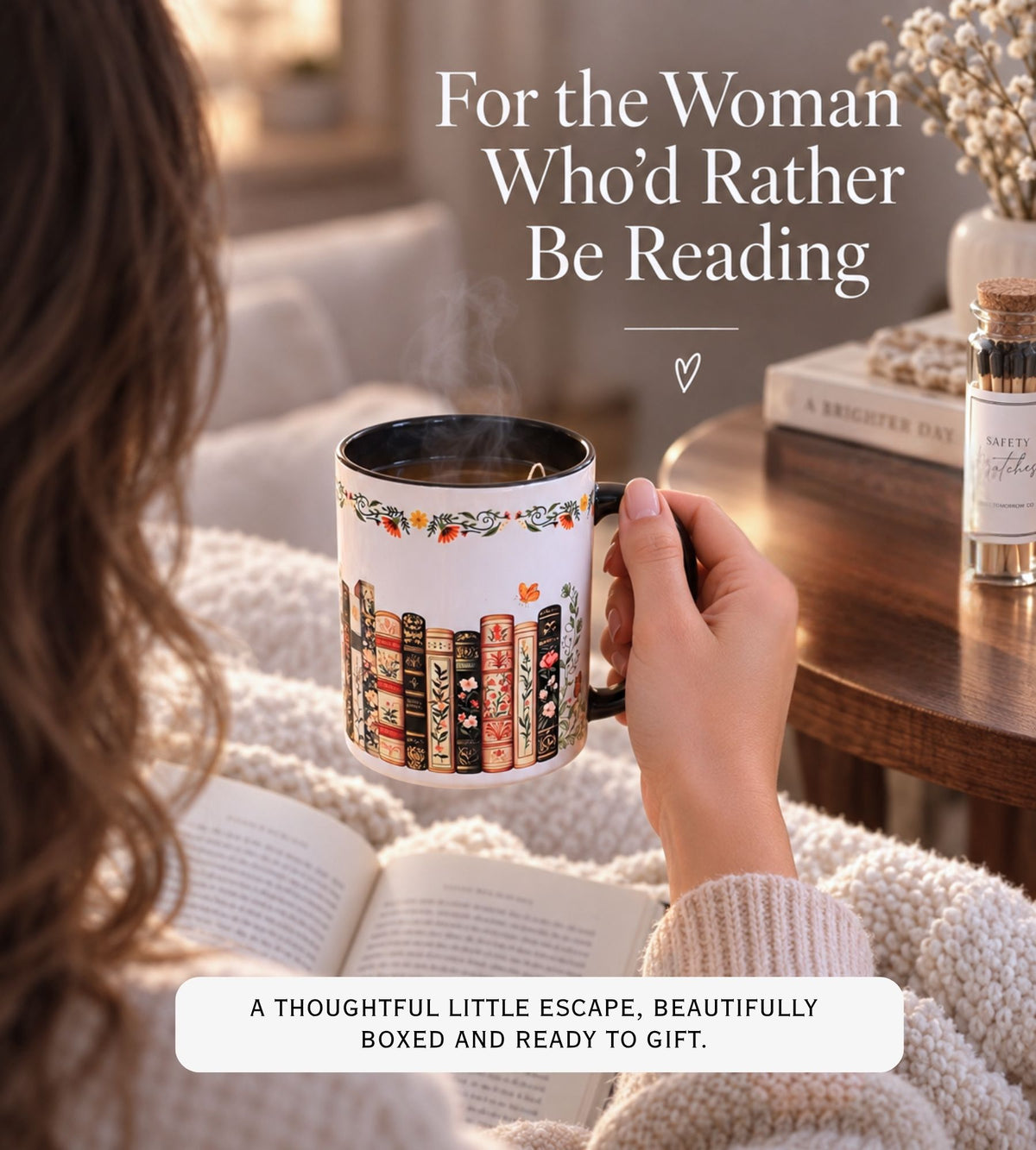 A person in a cozy living room setting holds a white ceramic mug decorated with colorful book spines and a floral border. The scene includes a book, a small bottle, and warm text overlays reading 'For the Woman Who'd Rather Be Reading' and 'A Thoughtful Little Escape, Beautifully Boxed and Ready to Gift.