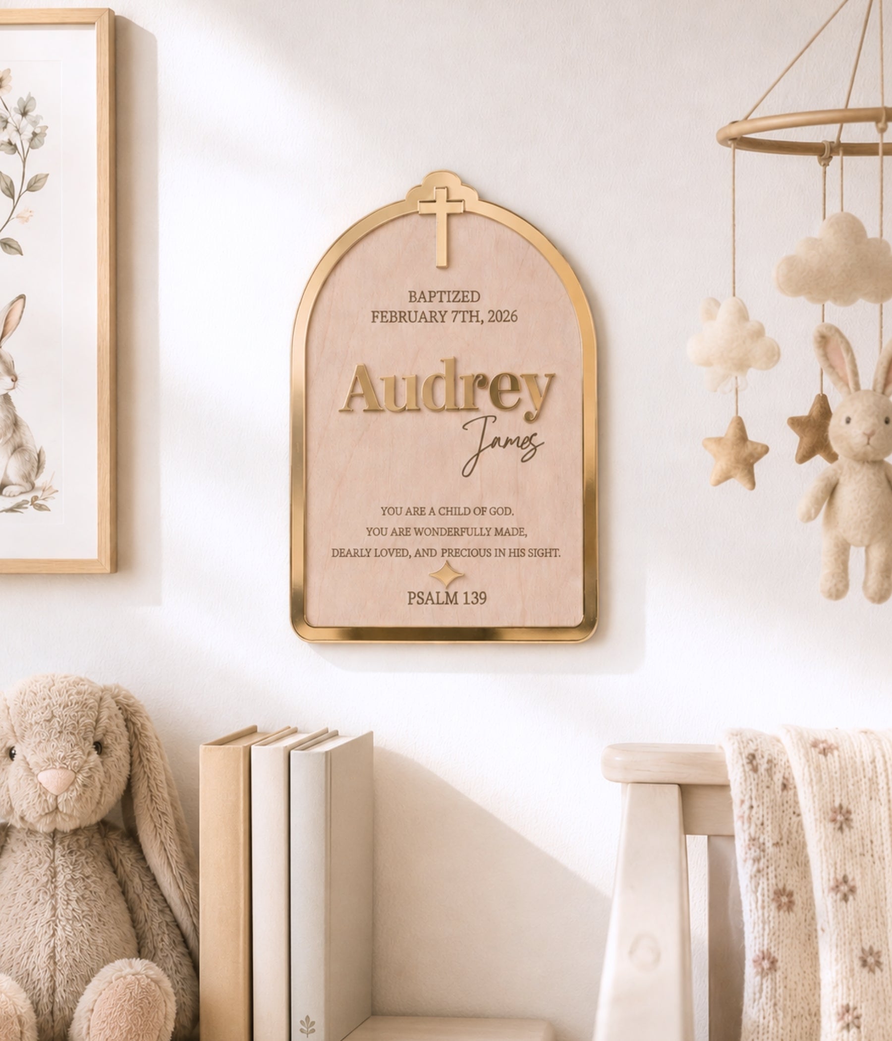 Baptism sign shown on a nursery wall, styled with white flowers and soft neutral decor