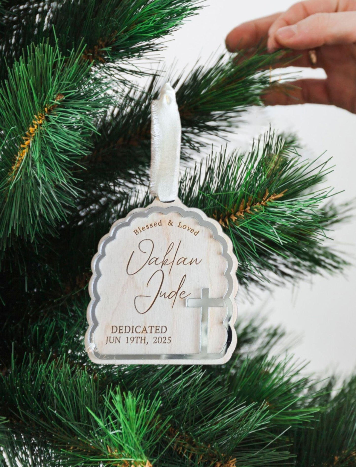 Wooden dedication ornament with silver cross design, custom name and event date.