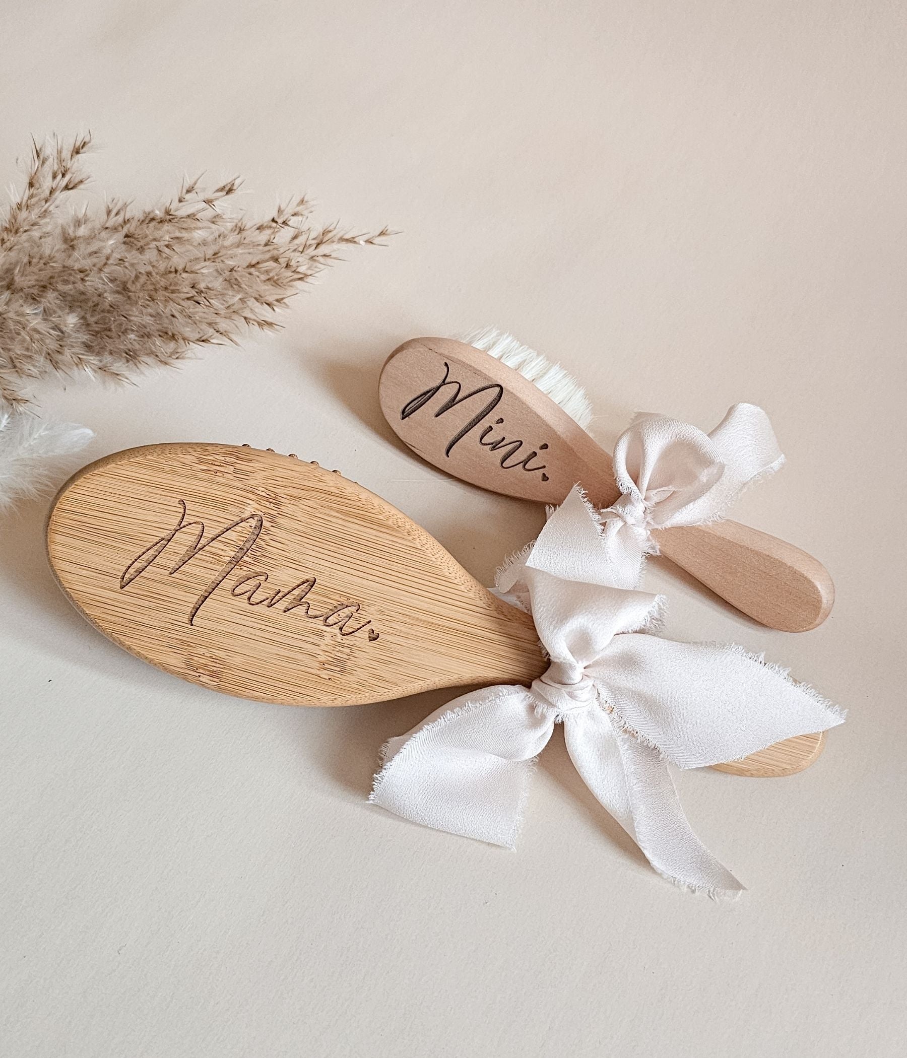 Personalized mom and baby hairbrush keepsake set with neutral styling and engraved names