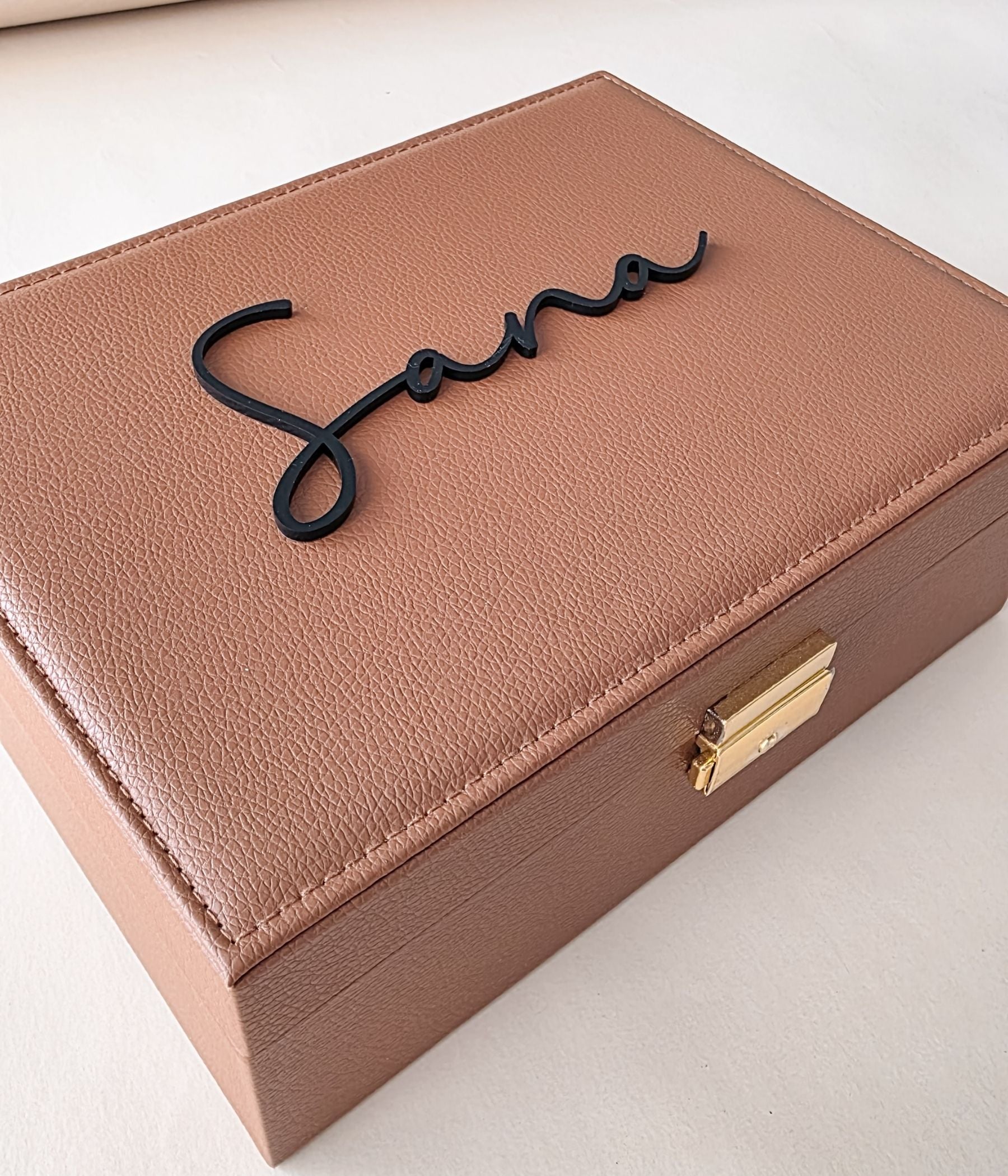 Brown keepsake jewelry box with ring slots and soft cream lining