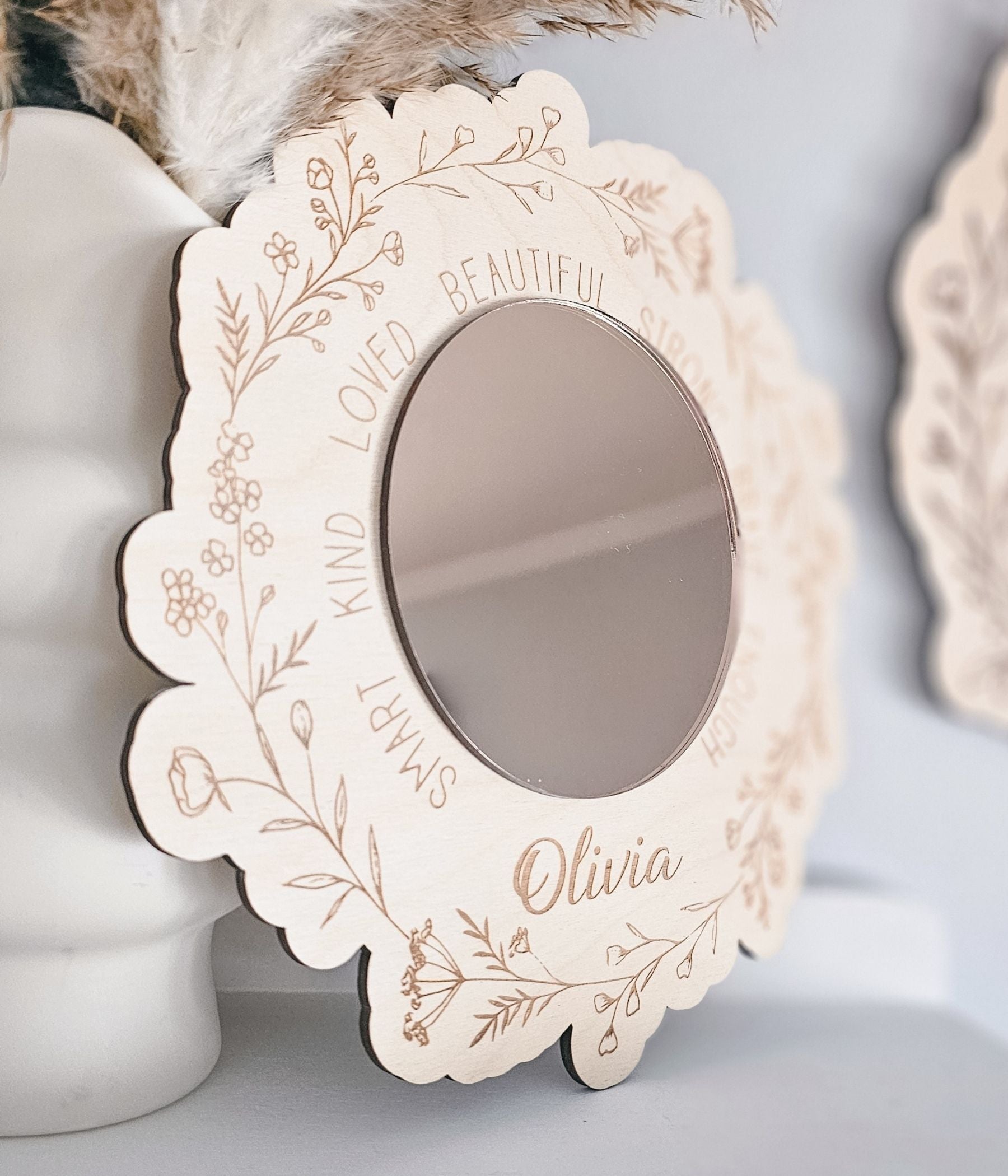 Personalized nursery mirror with acrylic center and custom child’s name in script lettering