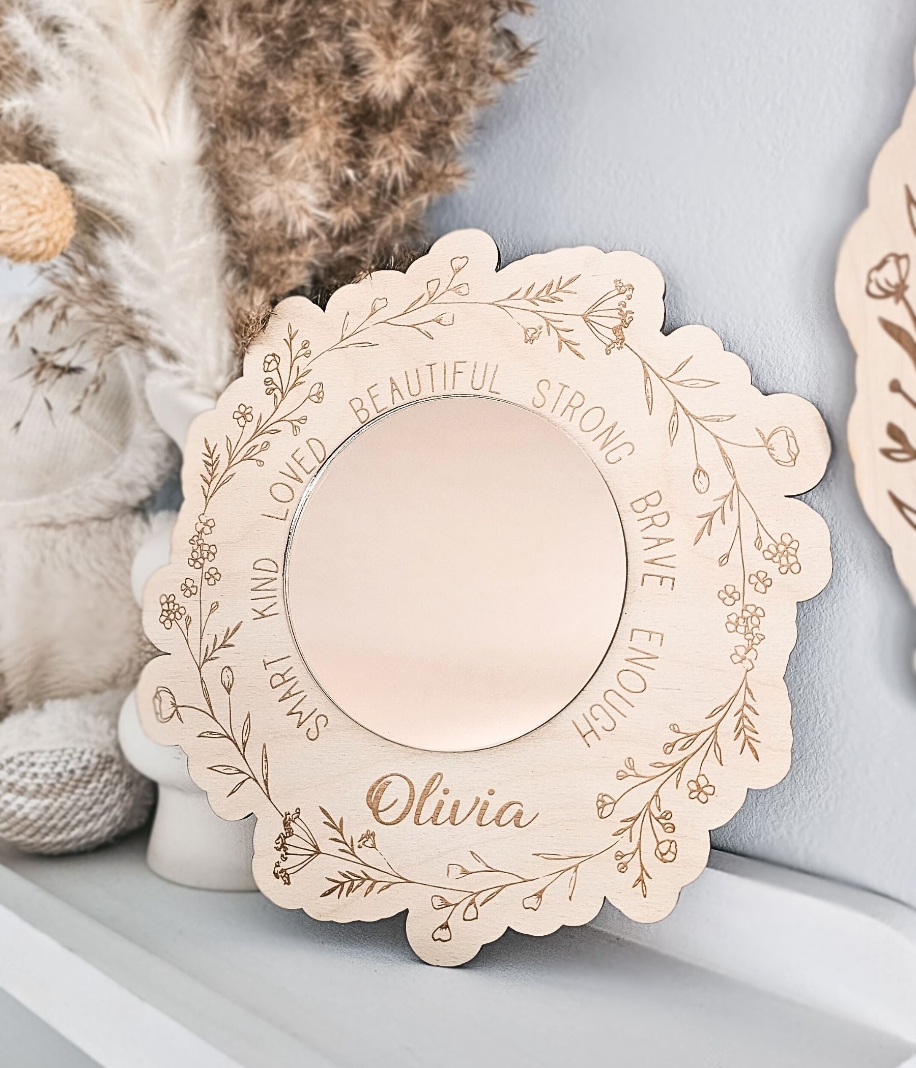 Personalized round acrylic mirror for a little girl’s room with scalloped wood edge and floral details