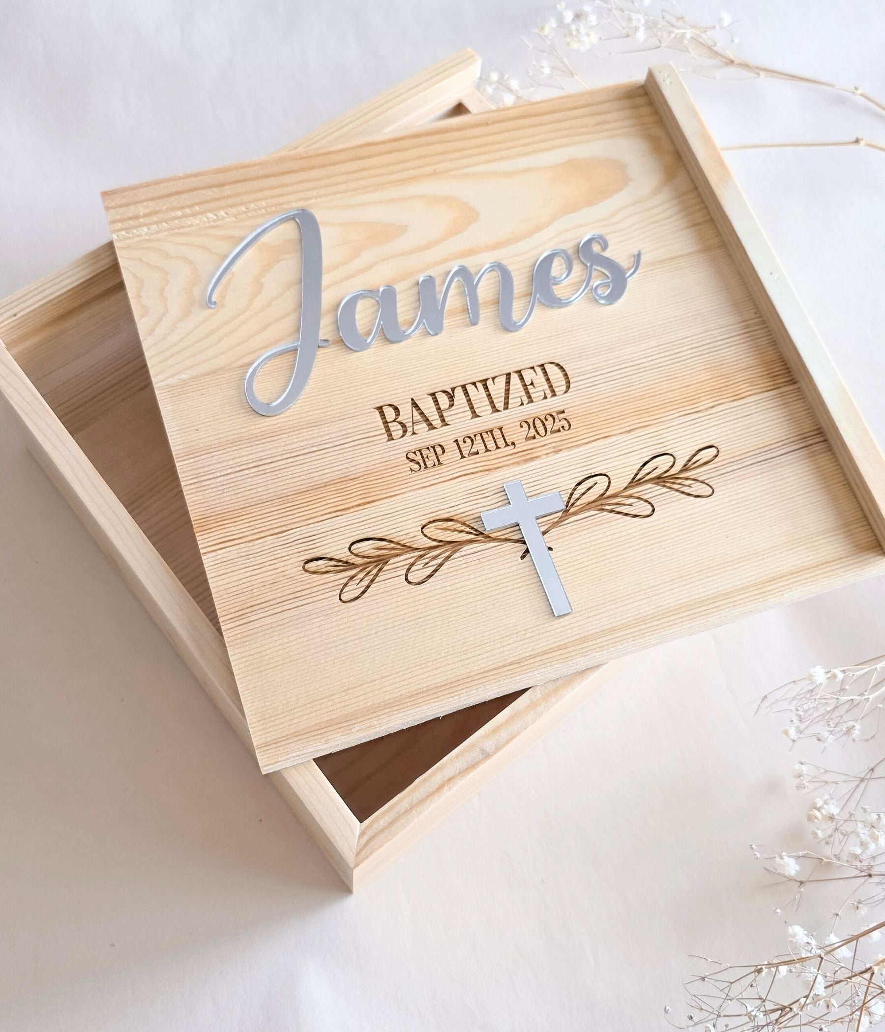 Close-up of personalized wooden keepsake box lid showing engraved baptized date and raised name accent