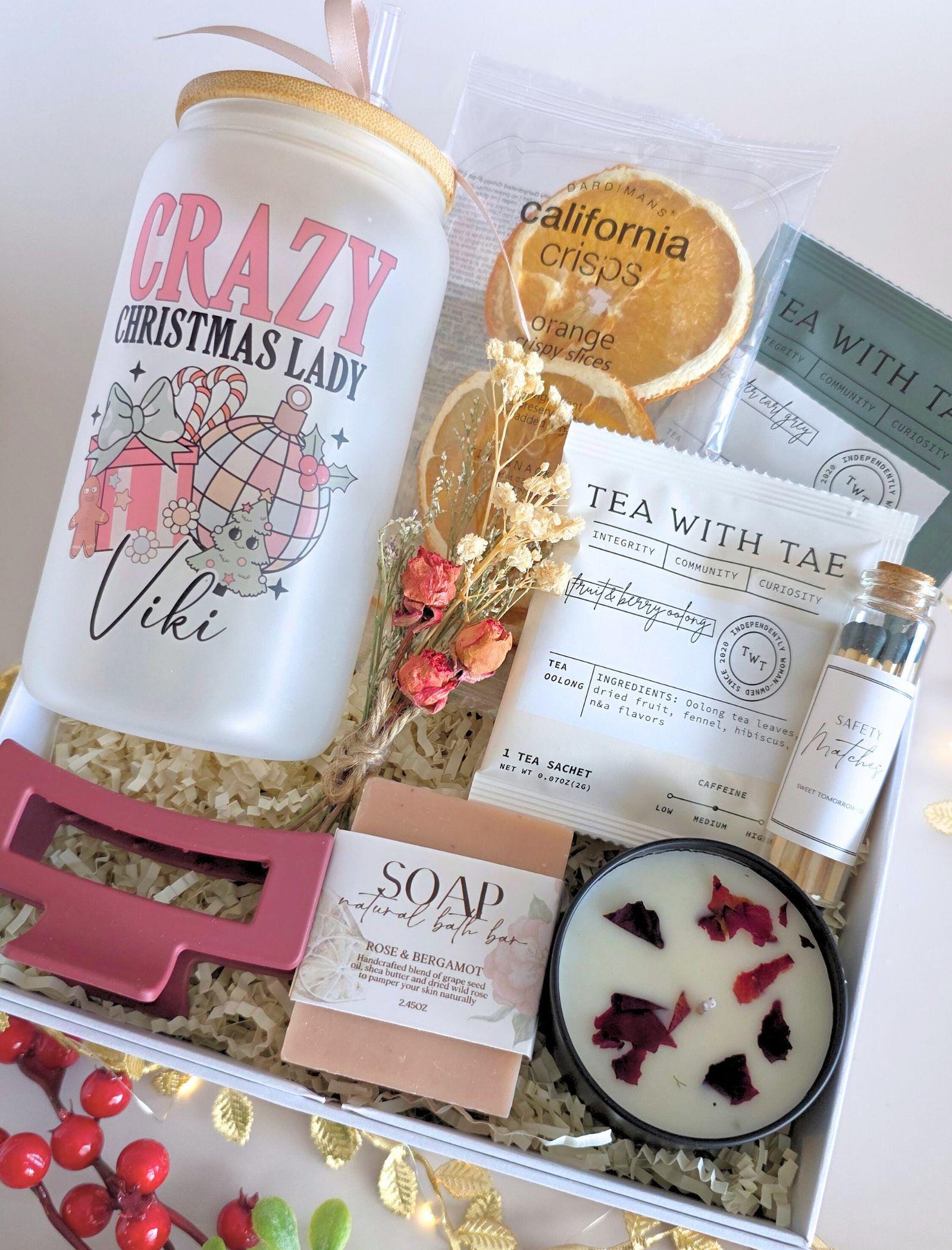 Curated Christmas gift box with tea and relaxing spa touches, modern pink holiday aesthetic
