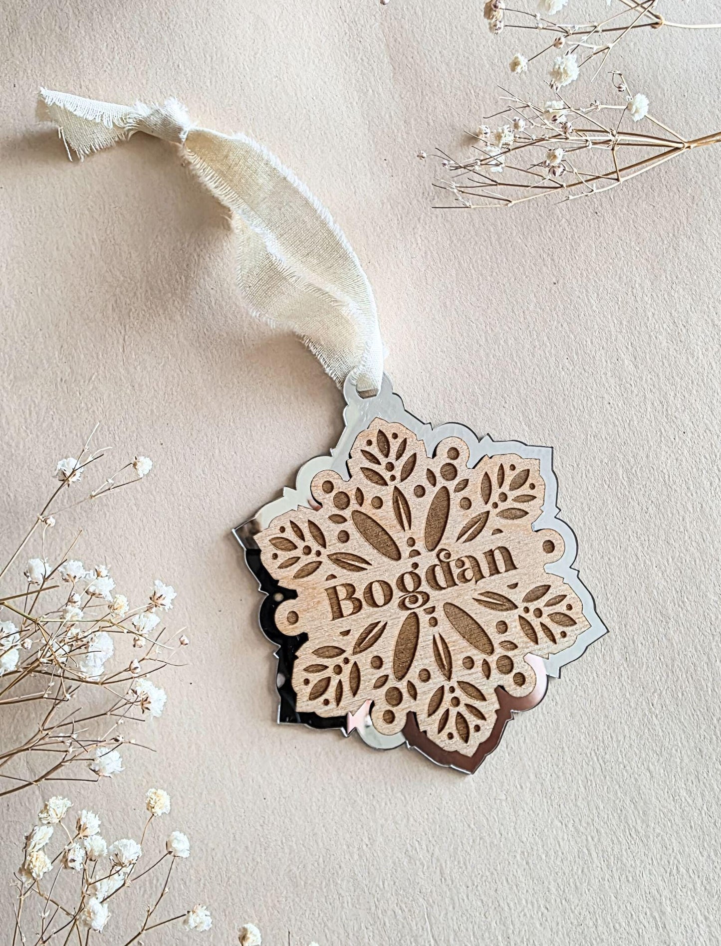 Holiday keepsake ornament with ribbon, personalized with name, perfect for Christmas tree décor.