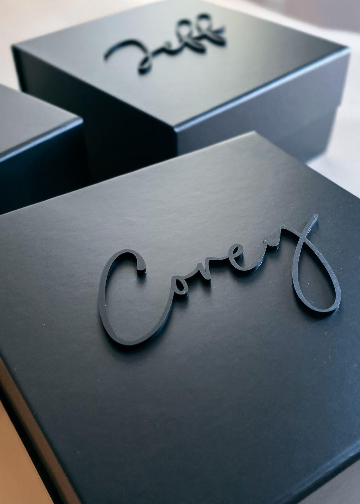 Elegant black magnetic box with personalized gold script for groom