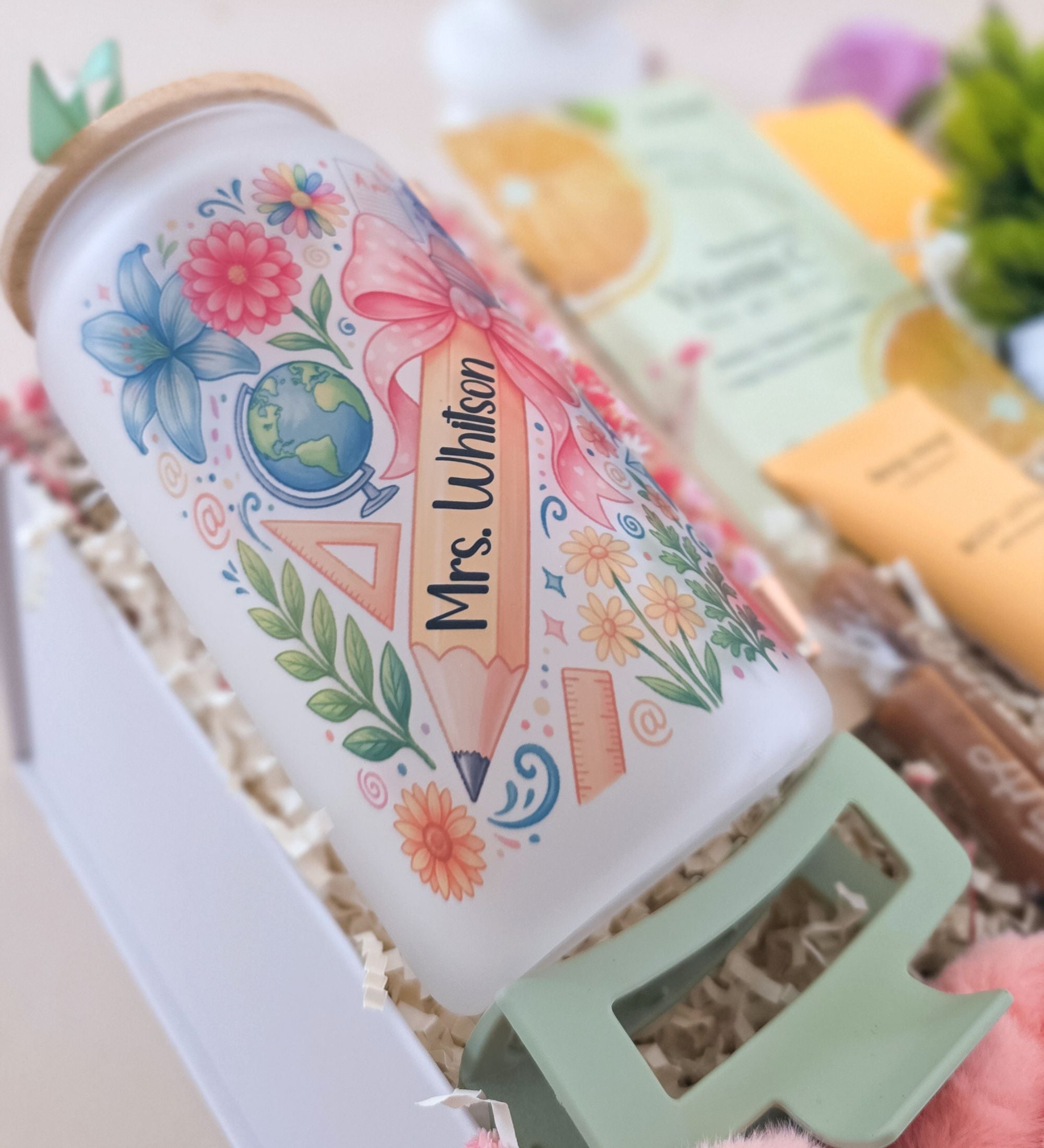 Close-up of personalized Mrs. Whitson coquette floral frosted glass tumbler with "Personalized with Name" callout, bamboo lid and acrylic straw detail, permanent print studio made label, styled with pink peonies
