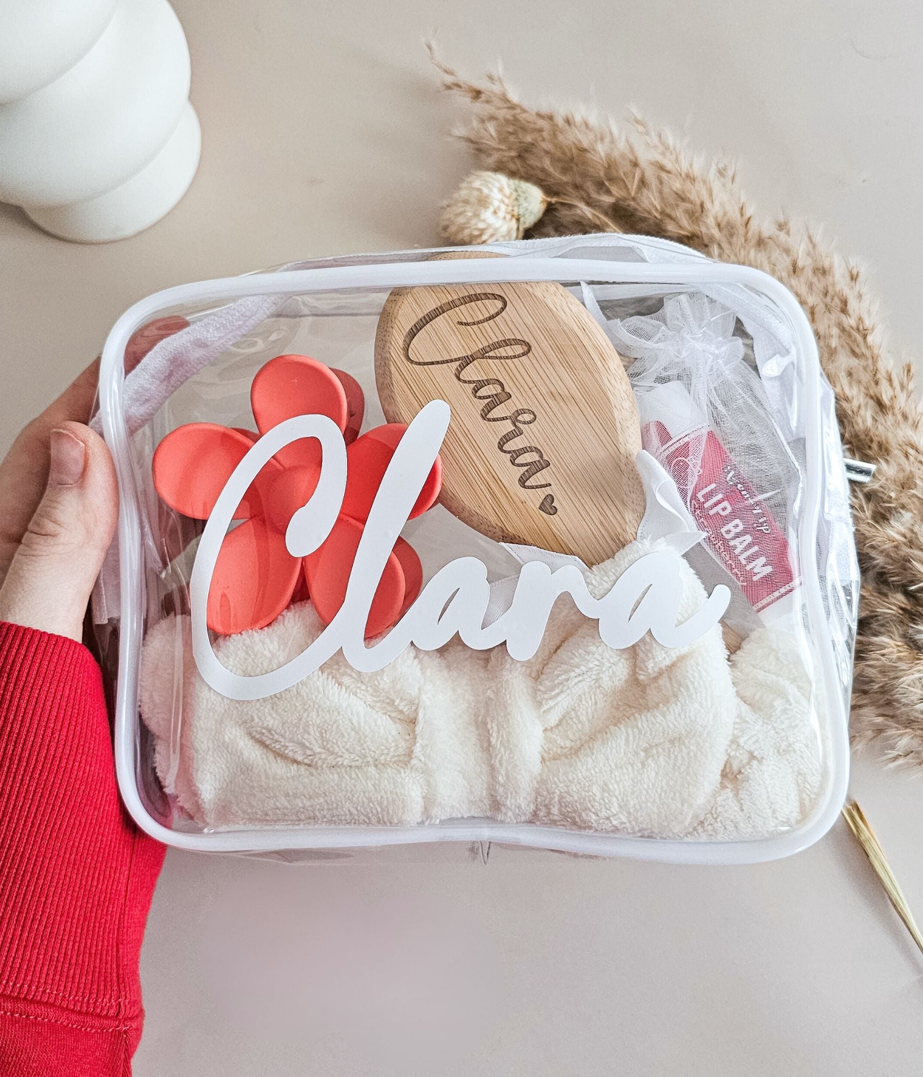 Personalized girls spa party favor bags with custom names, bamboo brushes, and colorful flower claw clips
