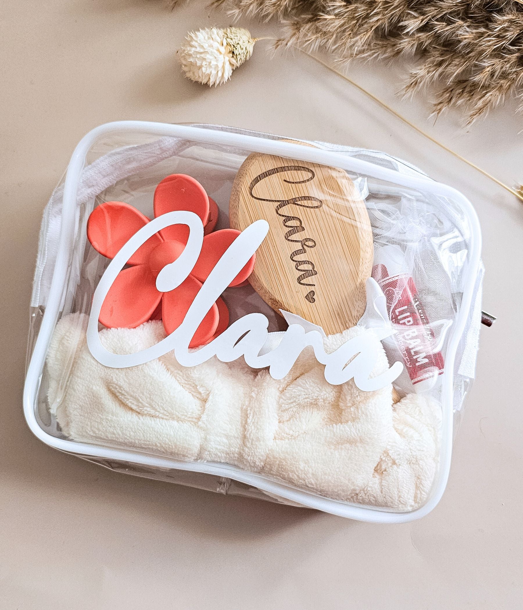 Clear zipper party favor bag for girls with engraved bamboo brush, lip balm, and plush spa headband