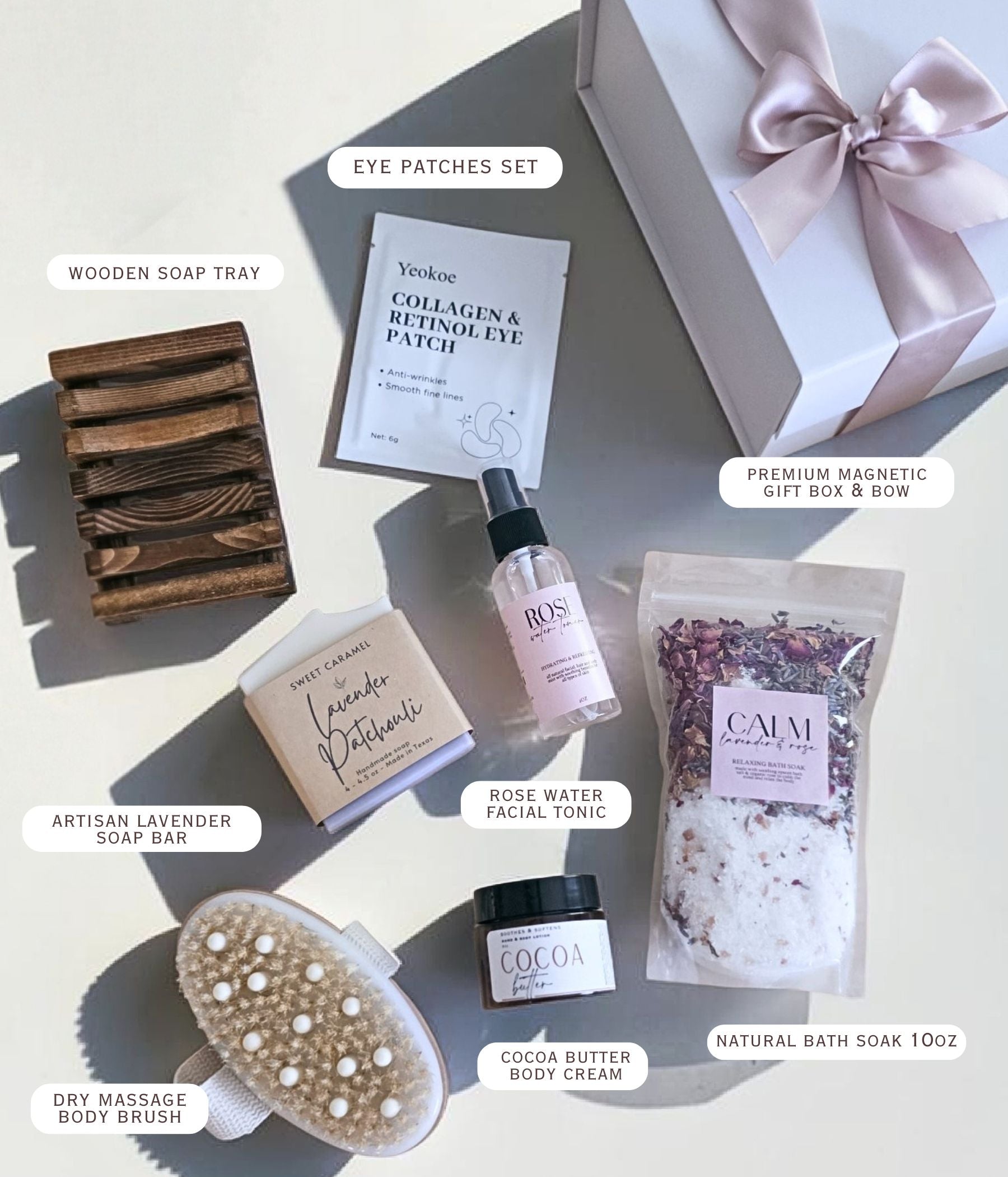 Every component of the self care package laid out flat on a neutral surface, nothing overlapping