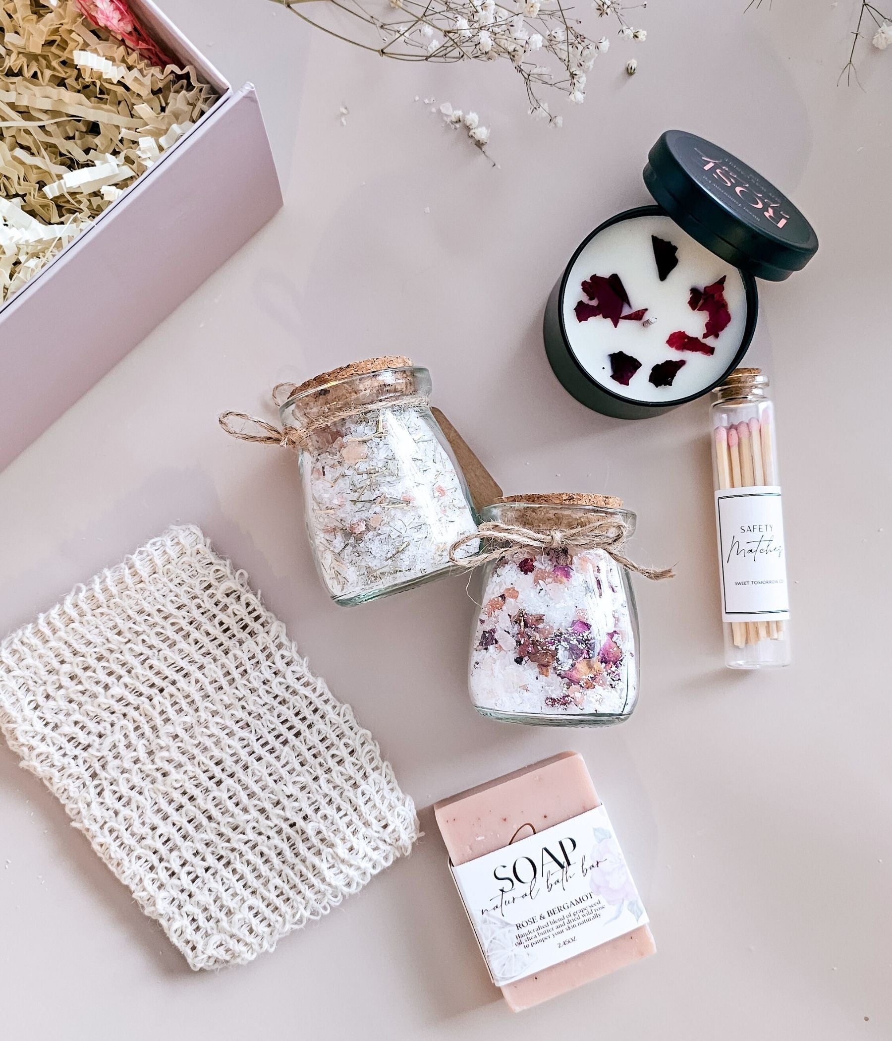 Soy wax candle with rose petals paired with natural soap and safety matches in gift box