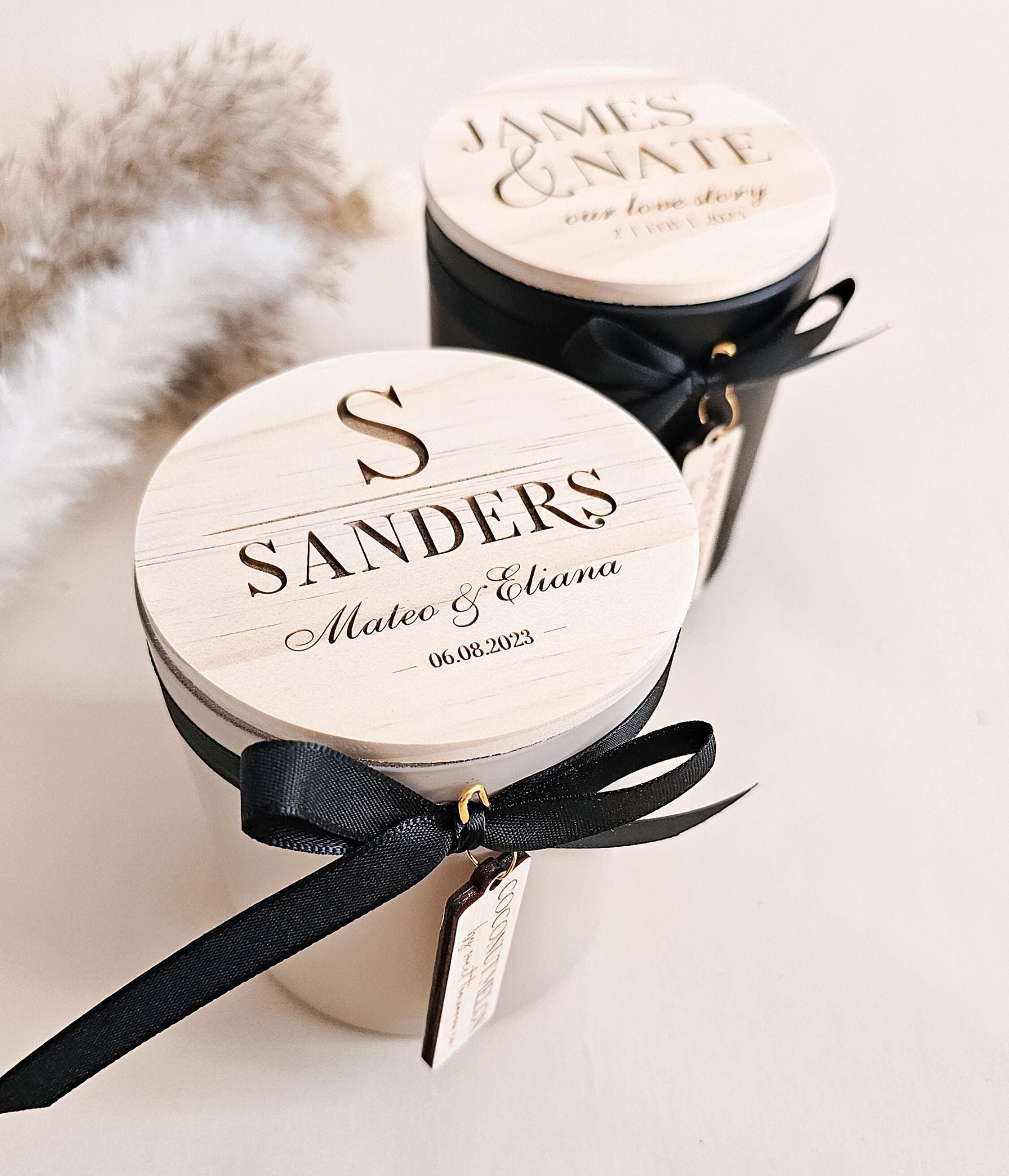 Personalized soy candle with engraved wooden lid showing last name and date, finished with black ribbon and wooden tag