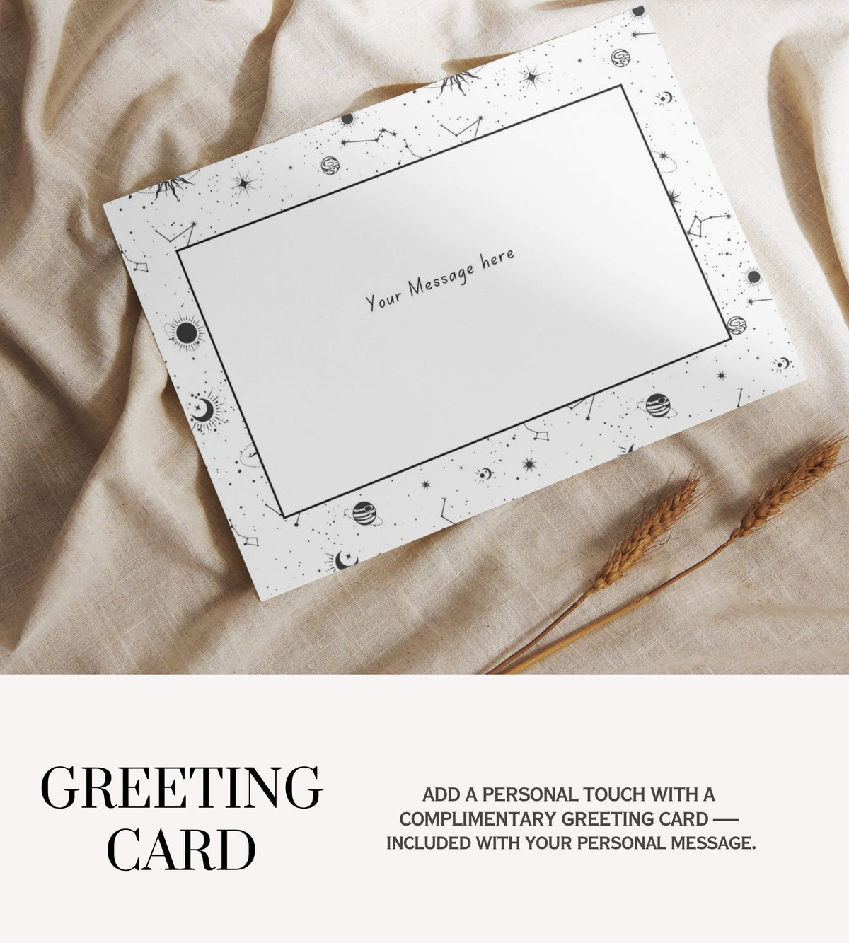 A white greeting card with a black celestial border of stars, moons, and constellations, laid flat on beige linen fabric next to dried wheat stalks. The bottom of the image features a text banner that reads 'GREETING CARD' and 'ADD A PERSONAL TOUCH WITH A COMPLIMENTARY GREETING CARD — INCLUDED WITH YOUR PERSONAL MESSAGE.