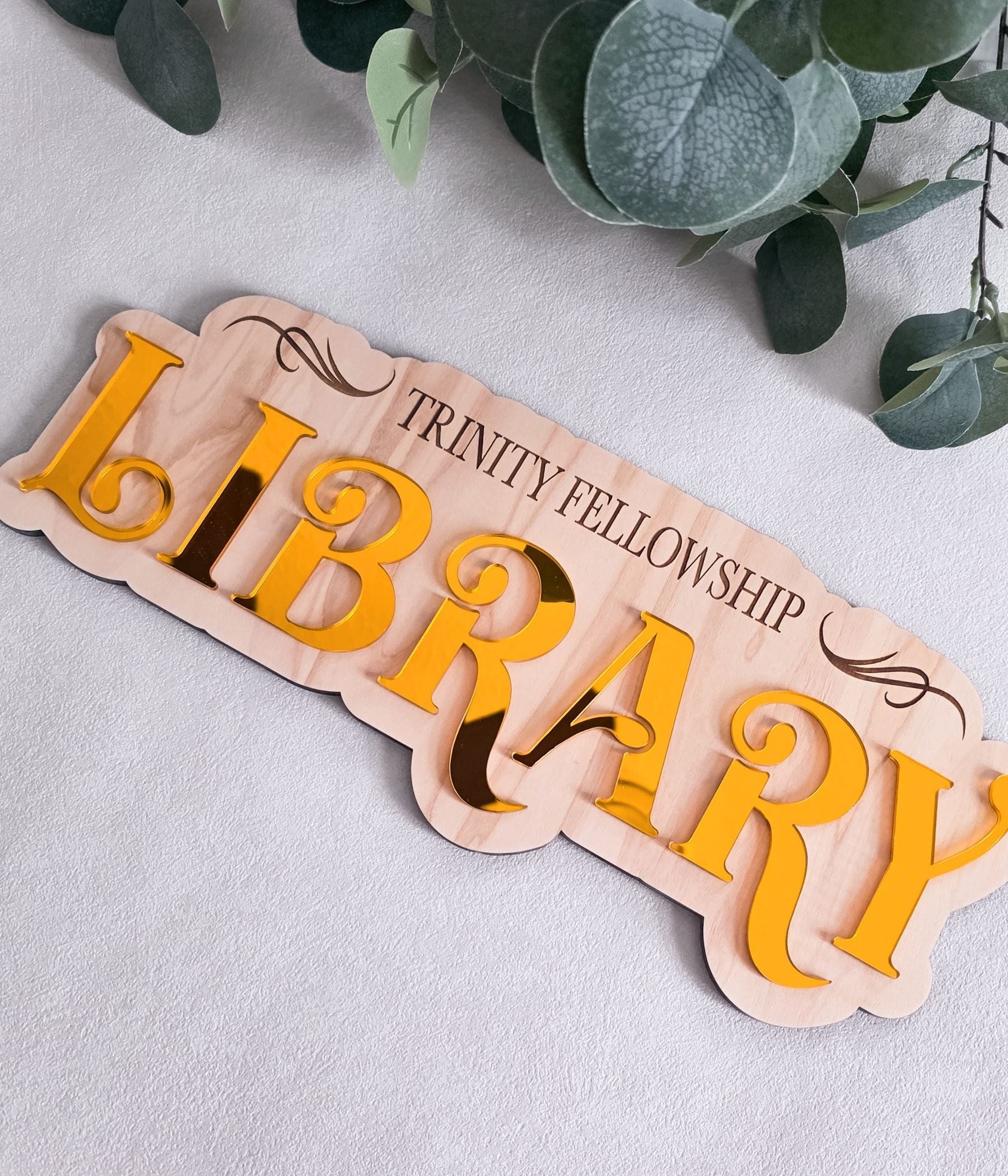 Nursery or library decor sign personalized with children’s names in colorful 3D lettering