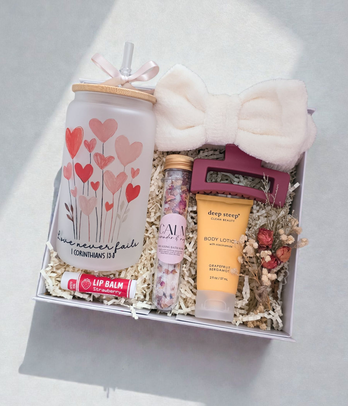 Christian gift box for women with Bible verse tumbler and self-care items arranged inside a magnetic gift box