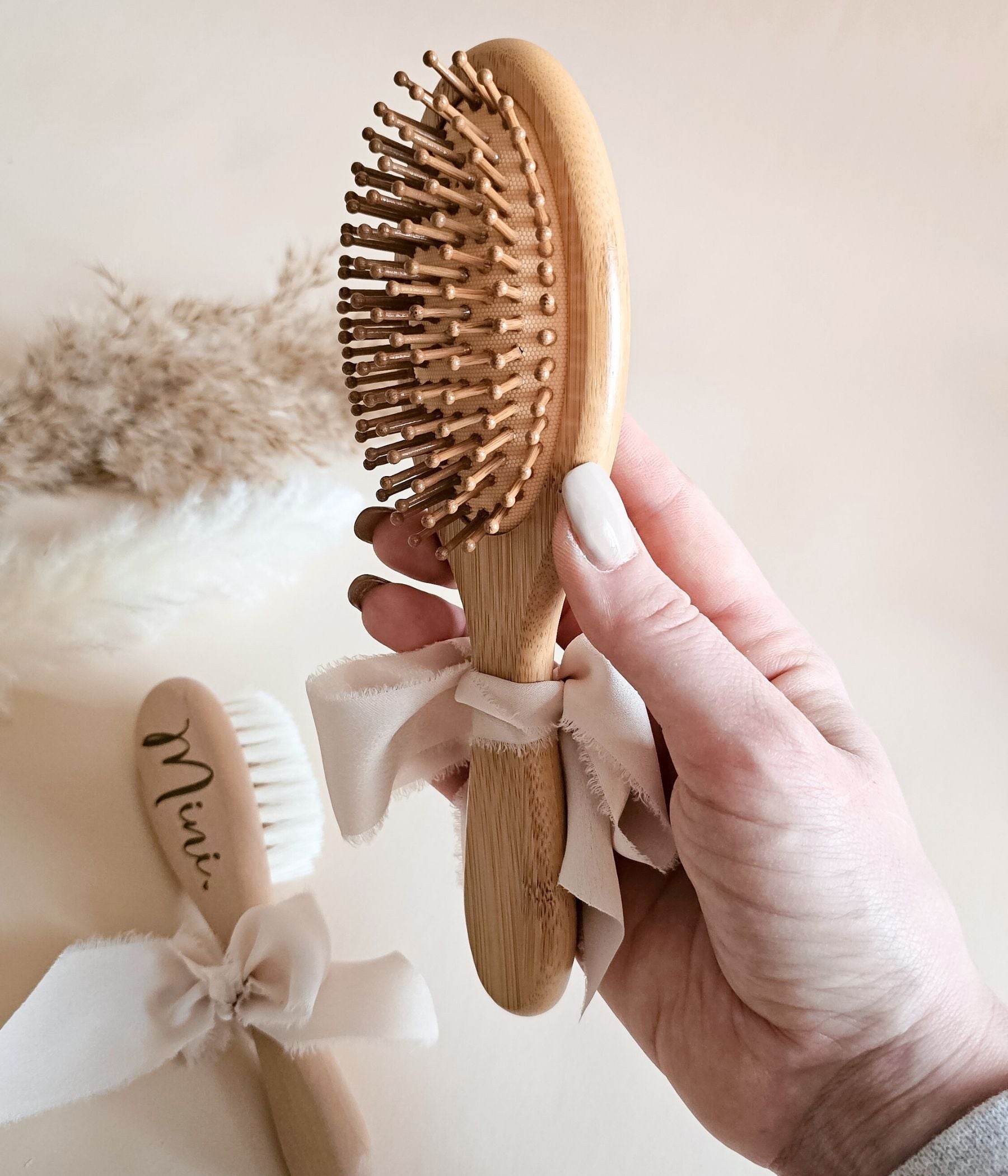Personalized mom and baby hairbrush keepsake set with neutral styling and engraved names