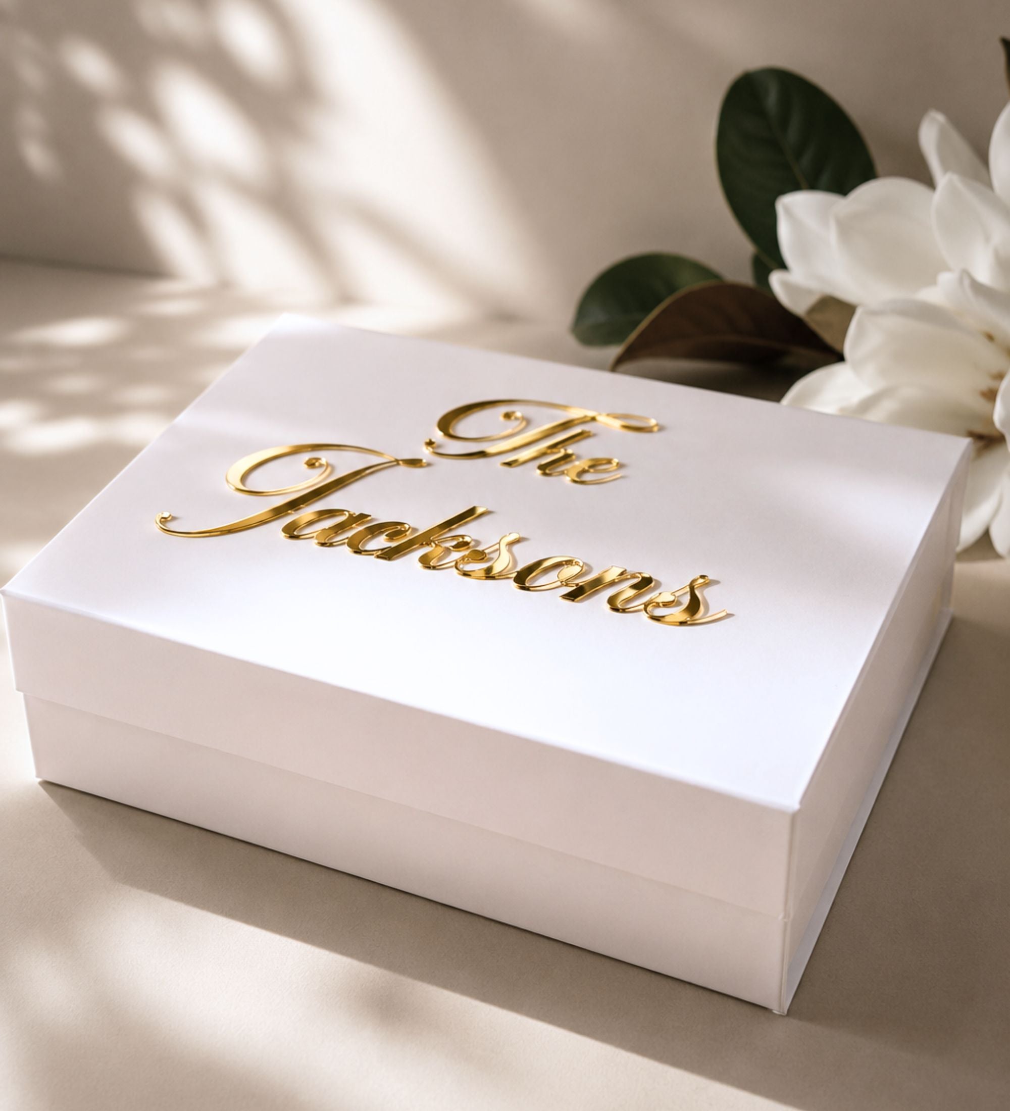 White wedding memory box with the married name in gold script, shown closed with its smooth matte finish