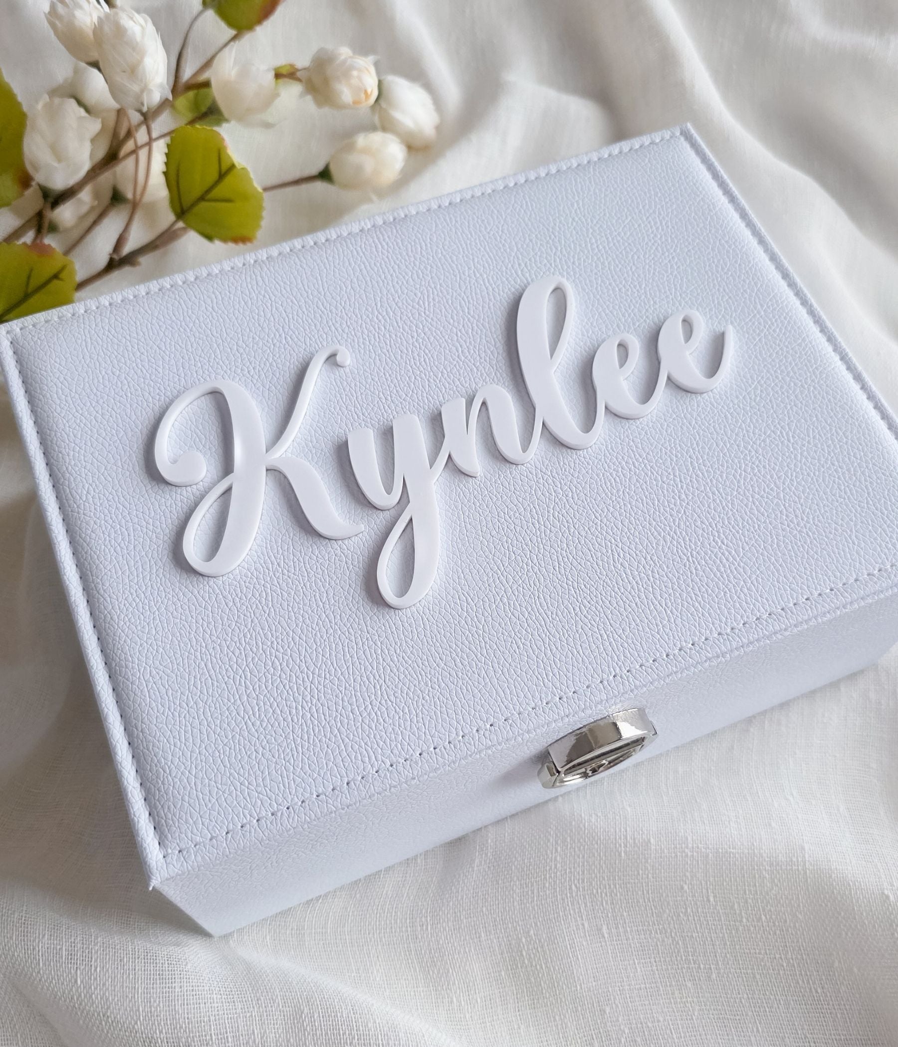 White keepsake jewelry box with soft blush interior and ring slots