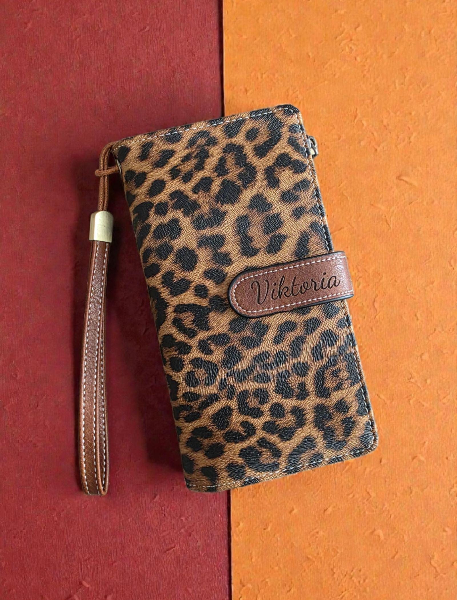 Close-up of engraved name on wallet strap showing personalized script font