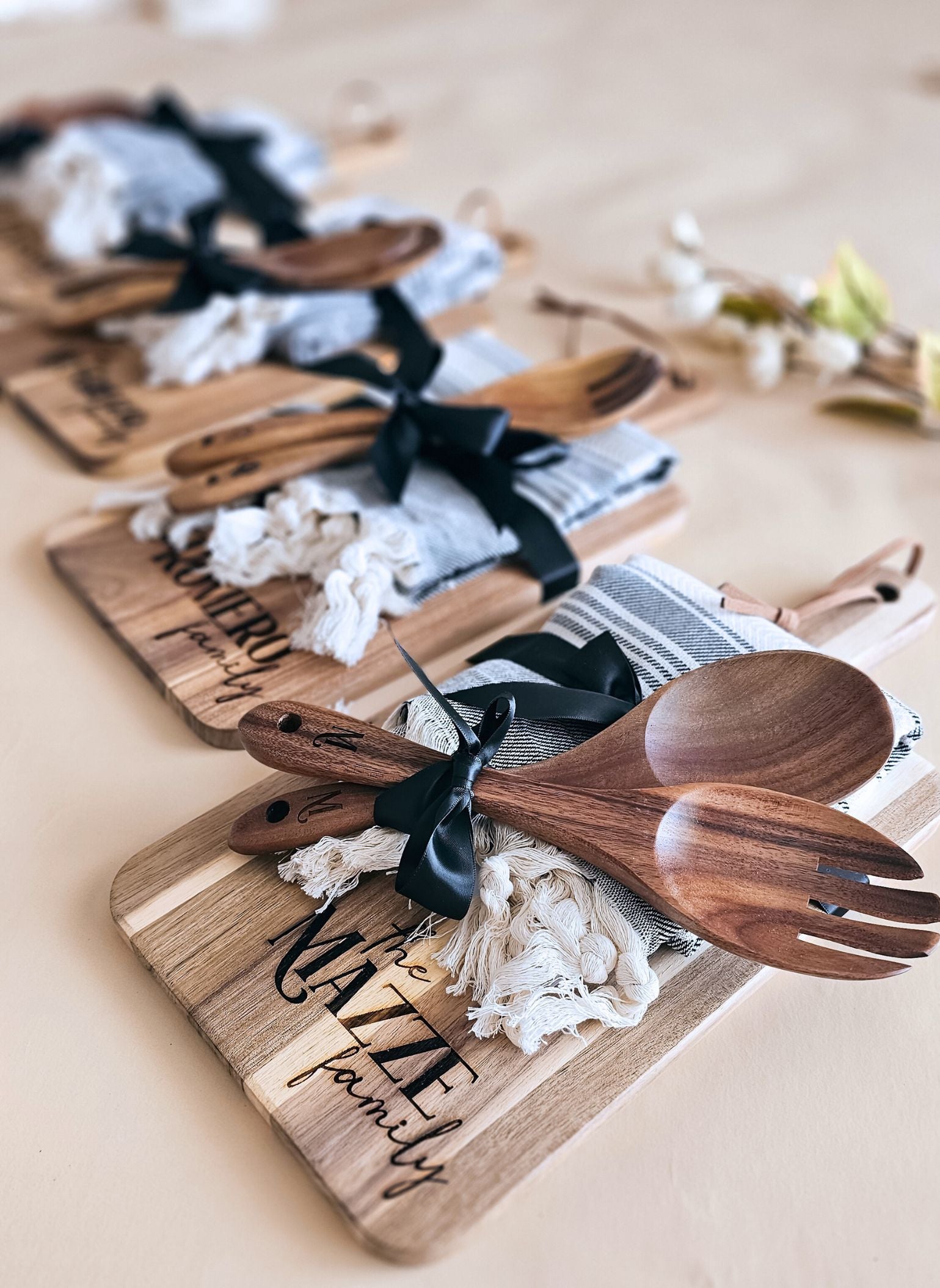 Gift packaging view: cutting board, salad spoons, and towel in bundled set for new homeowners